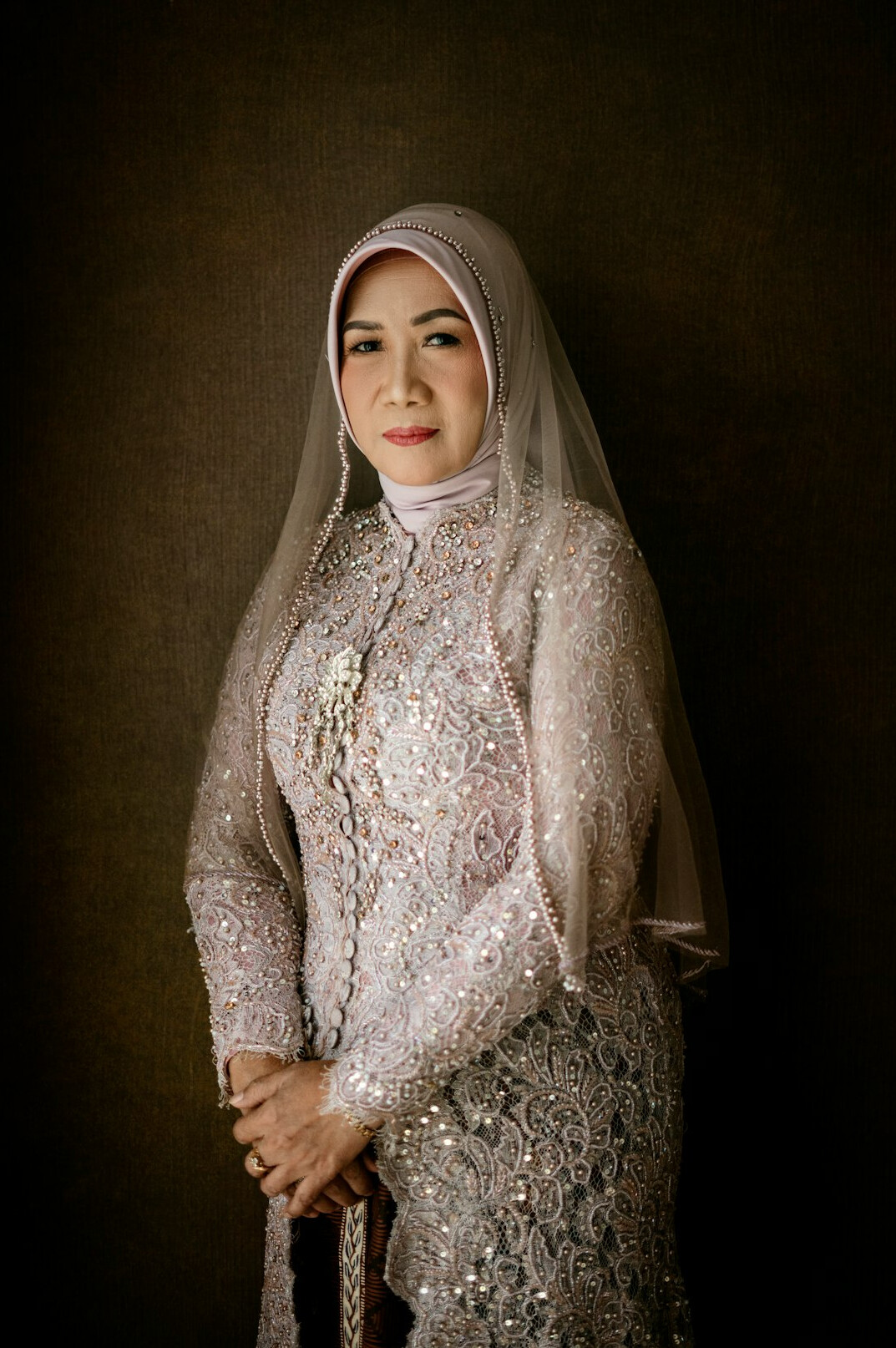 Studio portrait of an Indian-Malaysian business client smiling